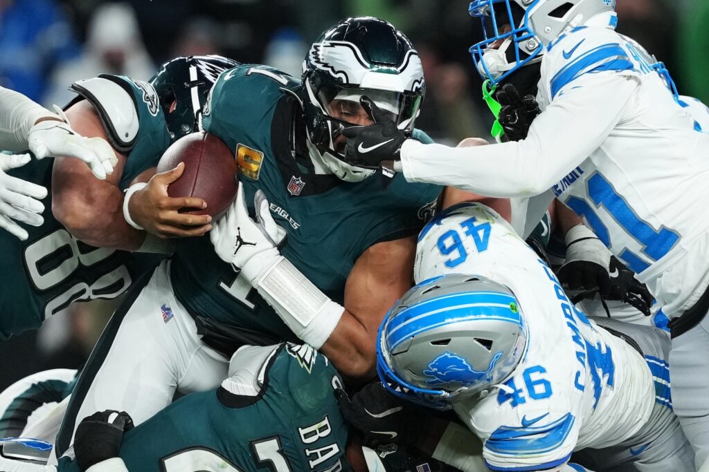 Lions Eagles Football Philadelphia Eagles quarterback Jalen Hurts (1) is stopped with the ball during the second half of an NFL football game by Detroit Lions linebacker Jack Campbell (46) and Lions cornerback Amik Robertson (21) Sunday, Nov. 16, 2025, in Philadelphia.