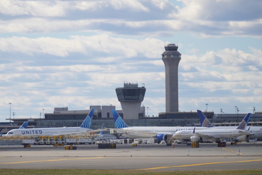 Government Shutdown Airlines Planes in front of air traffic control tower at Newark International Airport