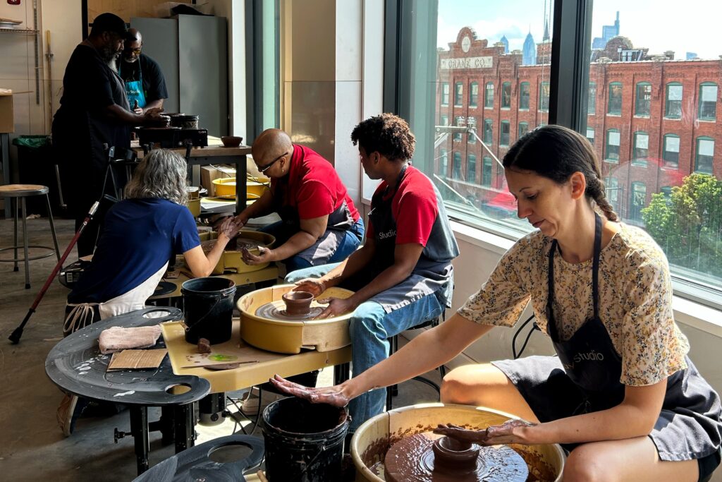 operation-mud-clay-studio-philadelphia-2025 Participants learning clay techniques on pottery wheels