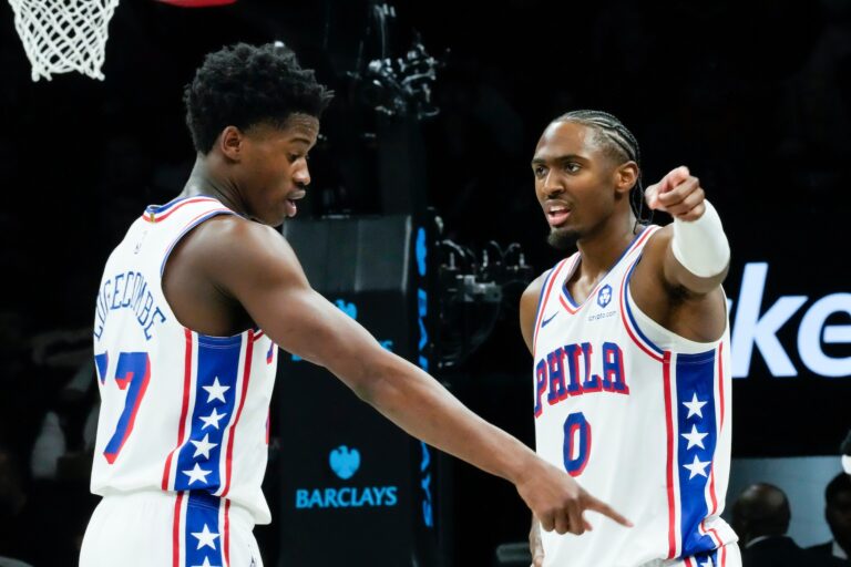 Philadelphia 76ers' VJ Edgecombe, left, talks to Tyrese Maxey (0)
