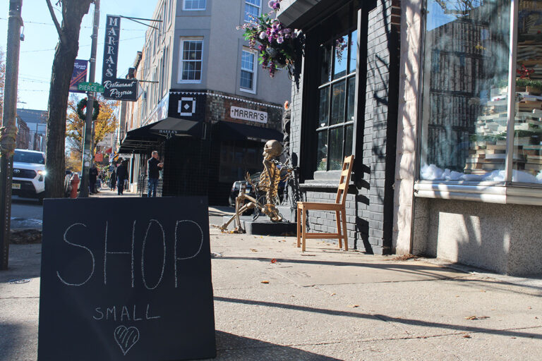 A chalkboard sign on the sidewalk reads 