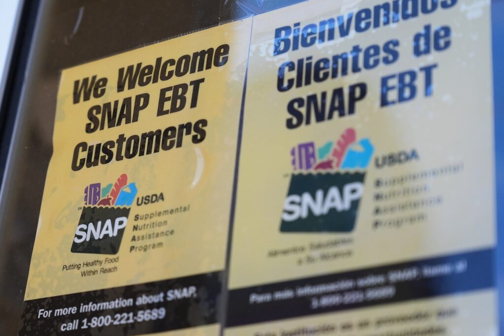 Government Shutdown Food Aid A sign with SNAP EBT information is posted on a store window