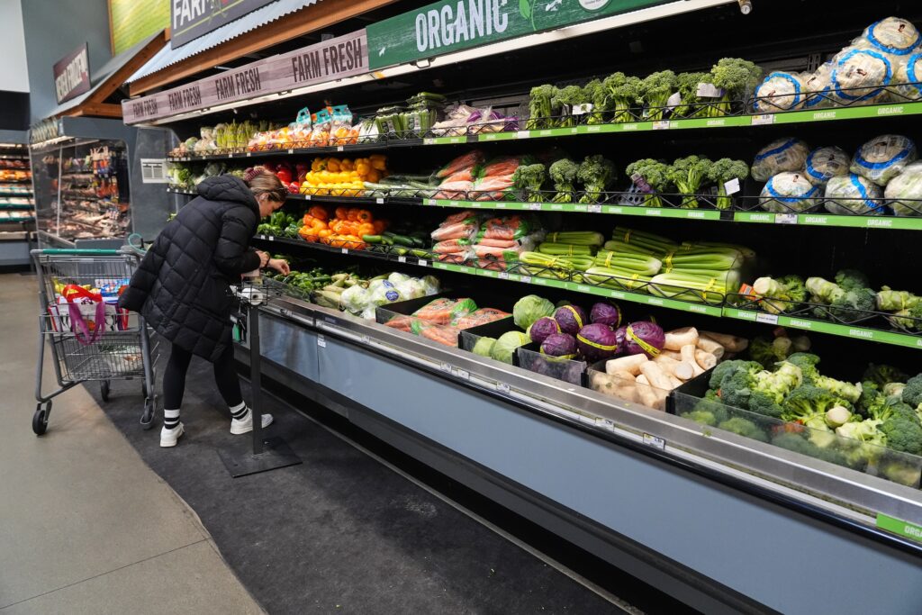 Government Shutdown Food Aid A person shops for produce at a grocery store
