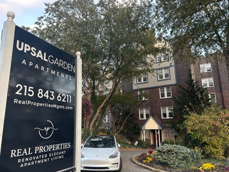 a sign for Upsal Garden Apartments