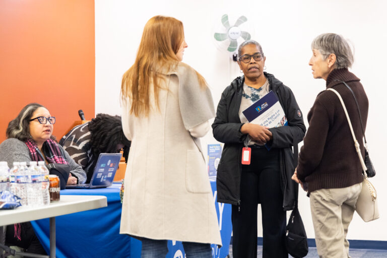 Attendees speak with each other during the resource fair