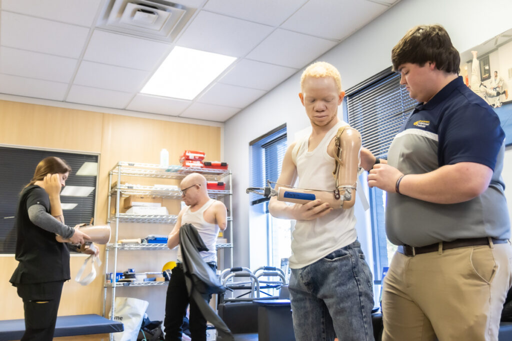 12 16 2025 1200x prosthetics for Tanzanians with albinism-2 Mwigulu and Emmanuel getting set up with new prosthetic arms from students