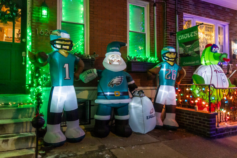 Inflatable decorations outfitted with various Philadelphia sports' teams jerseys on display at the Miracle on South 13th Street light display