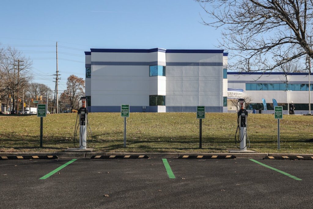 2022-12-21-K-PAYNTER-camden-county-charging-stations-18 A parking lot with EV chargers in front of two spaces