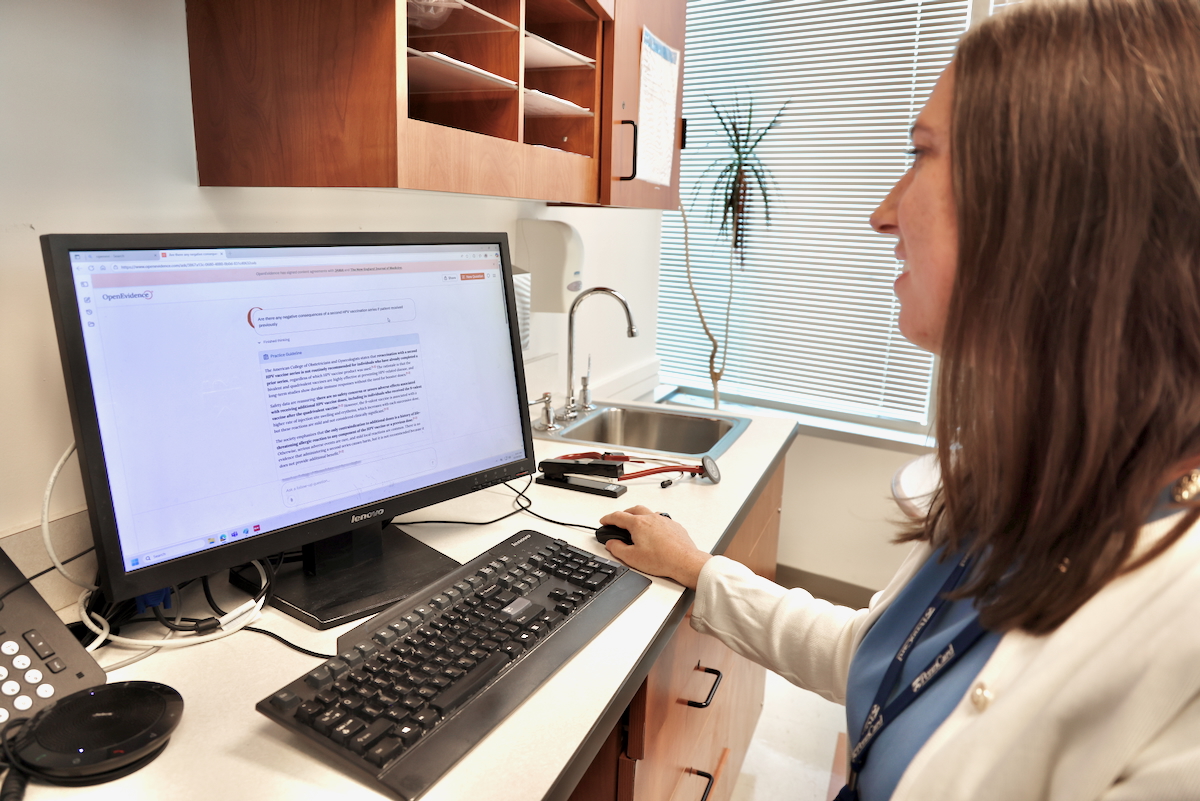 Corinne Rhodes looks at a computer