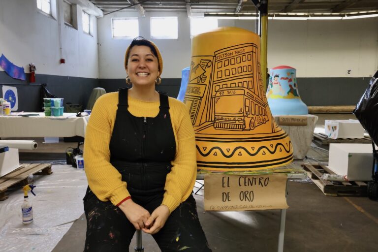 Symone Salib posing for photo with bell