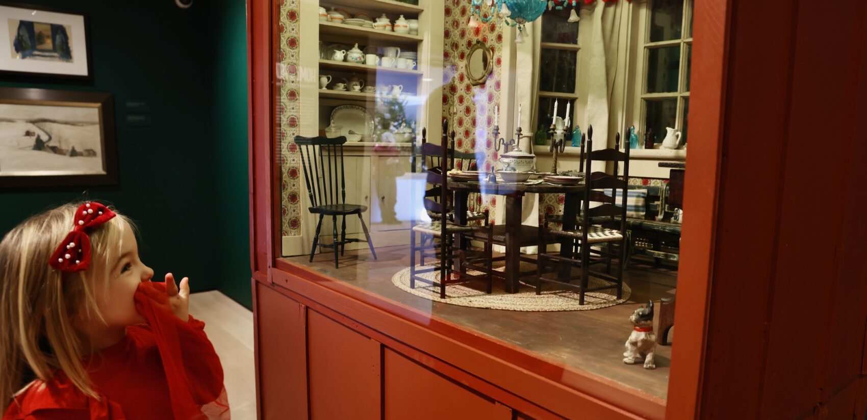 A child delights at the sight of the elaborately detailed dining room ofAnn Wyeth McCoy's dollhouse,