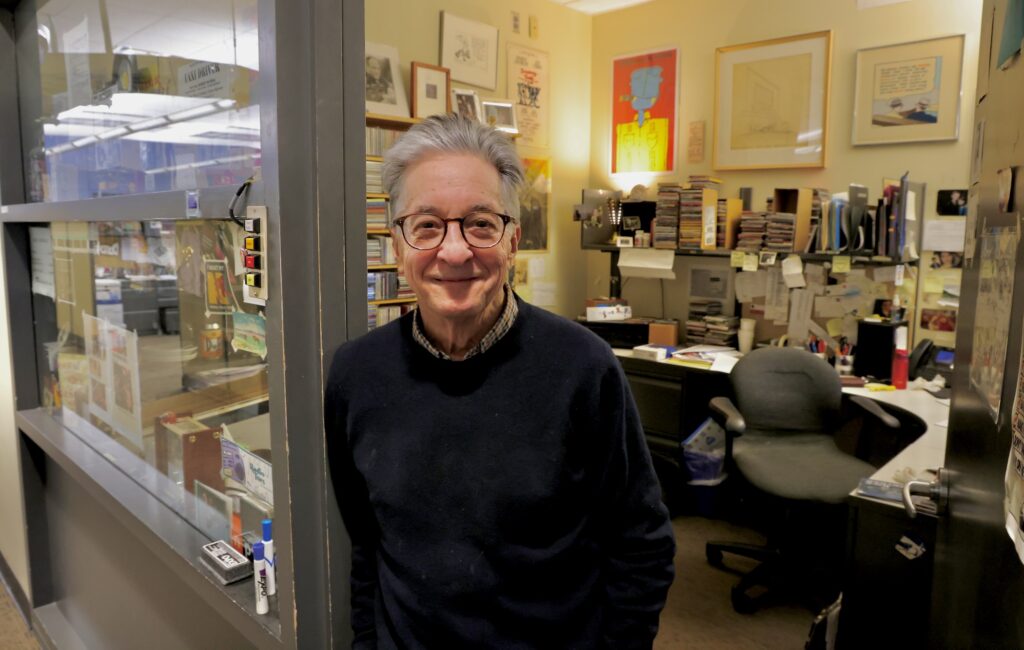 WHYY's Danny Miller stands at the entrance to his office