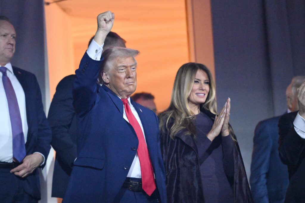 donald-melania-trump-2025-12-05-ap President Donald Trump pumps his fist alongside first lady Melania Trump