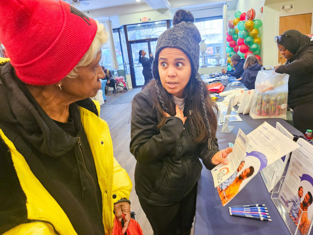 pennie-fair-pennsylvania-NL-122225-01 Laura Polo talking with fair attendee about health insurance