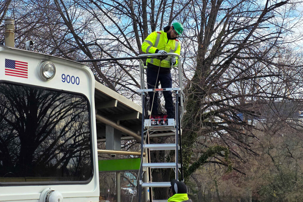 septa-workers-t-macdonald-2025-12-17-2 Worker up on a ladder working on a power line