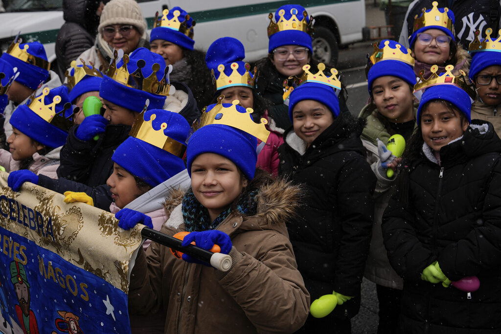 Kids carry a banner during El Museo del Barrio's 47th annual Three Kings Day parade in New York