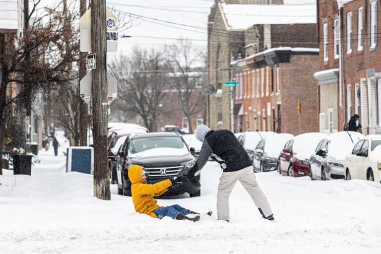 A resident gets a hand out of the snow in Philadelphia’s Fishtown neighborhood on Jan. 25, 2026.