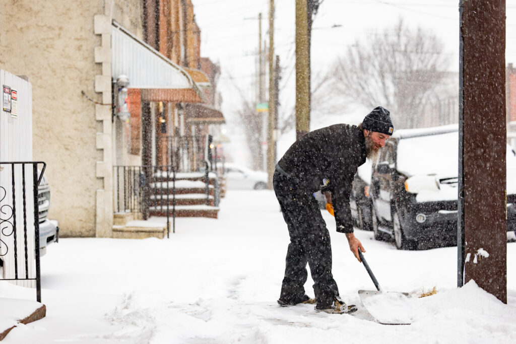 01 25 2026 k paynter sunday morning snow -11 Kevin Gallagher shoveling snow from the sidewalk in front of his home during a snowstorm
