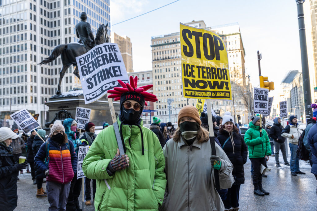 Two South Philadelphians hold signs at a protest against ICE