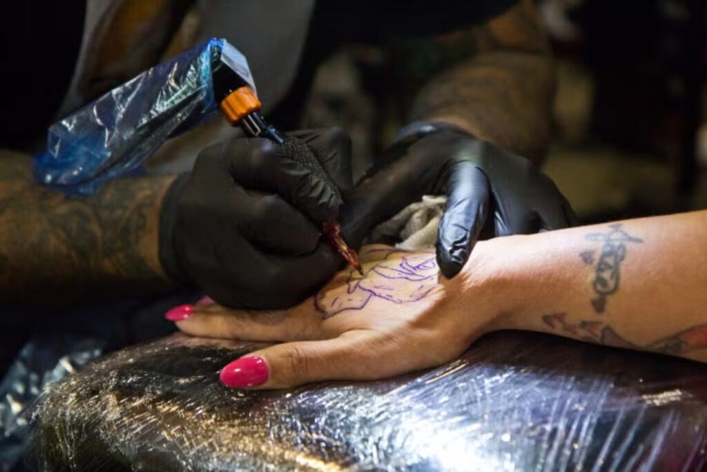 2020-1-17-k-paynter-tattoo-2020-12-768×512-file-new A rose being tattooed onto a hand