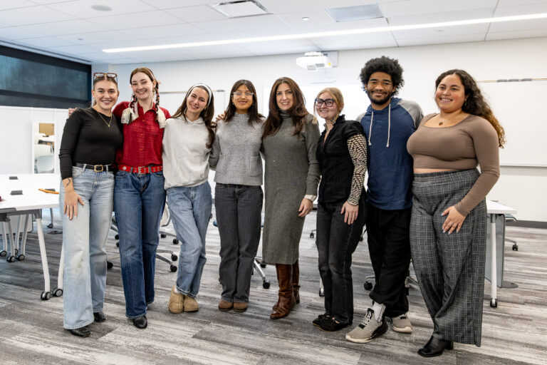 Students in the fashion design program smile