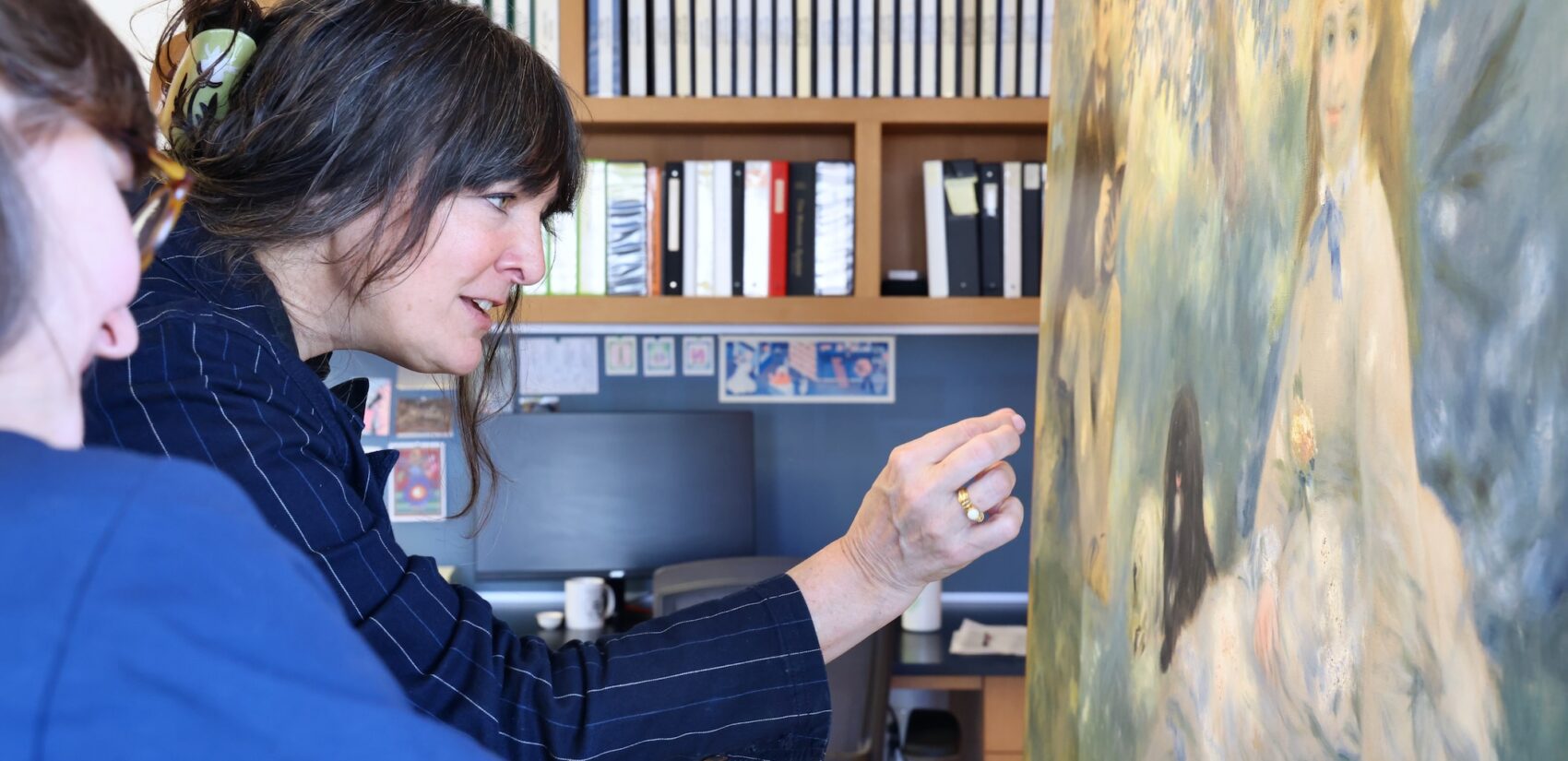 Deputy Director for Research, Interpretation and Education Martha Lucy admires a partially restored painting by Pierre-Auguste Renoir in the Conservation Studio at The Barnes Foundation. (Emma Lee/WHYY)