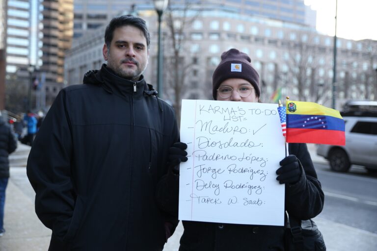A person holds a Venezuelan flag outside the Cathedral Basilica of Saints Peter and Paul