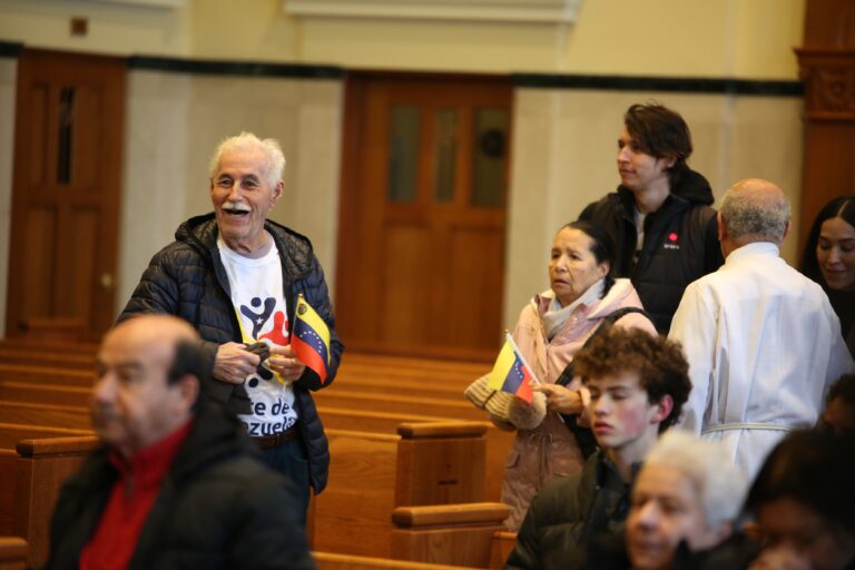 People hold Venezuelan flags at the Cathedral Basilica of Saints Peter and Paul