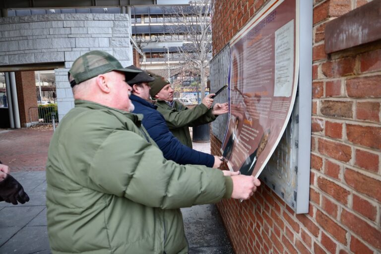 National Park Service employees remove signage related to enslaved people from the President’s House site on Independence Mall