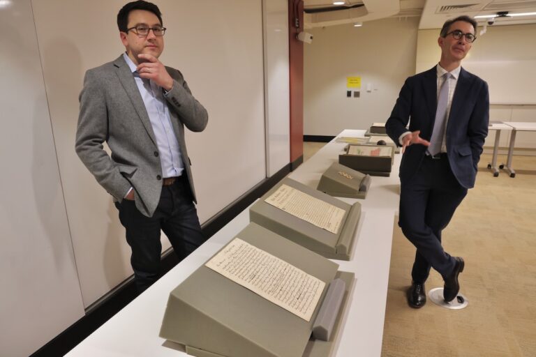 Curators Michael Blaakman (left) and Gabriel Swift (right) posing for photos