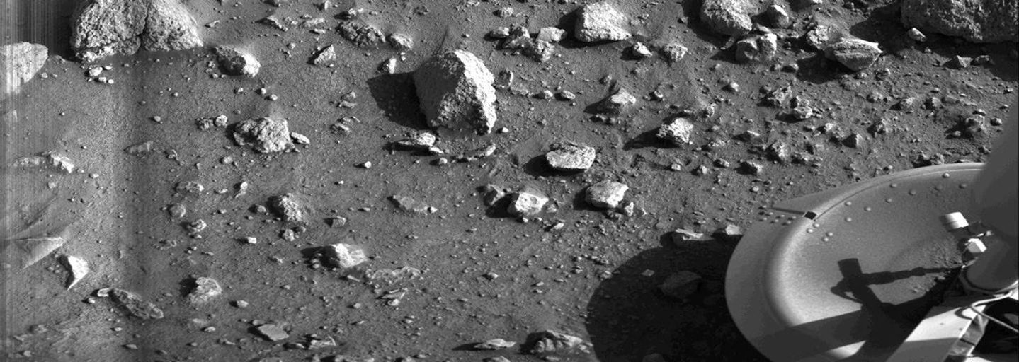Taken by the Viking 1 lander shortly after it touched down on Mars, this image is the first photograph ever taken from the surface of Mars. It was taken on July 20, 1976. The primary objectives of the Viking mission, which was composed of two spacecraft, were to obtain high-resolution images of the Martian surface, characterize the structure and composition of the atmosphere and surface and search for evidence of life on Mars. (NASA)