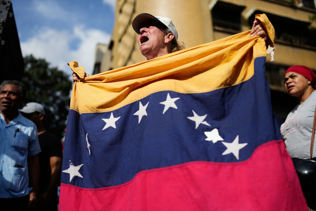 Venezuela US Government supporters rally in Caracas, Venezuela, Saturday, Jan. 3, 2026, after President Donald Trump announced that U.S. forces had captured Venezuelan President Nicolás Maduro and his wife. (AP Photo/Ariana Cubillos)