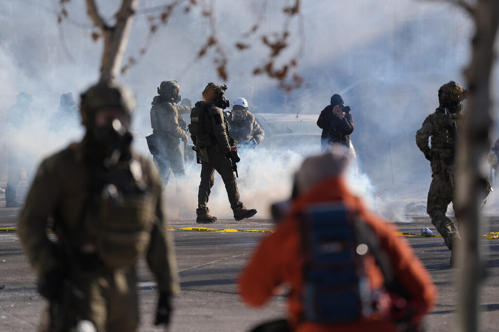 Federal immigration officers deploy tear gas at protesters