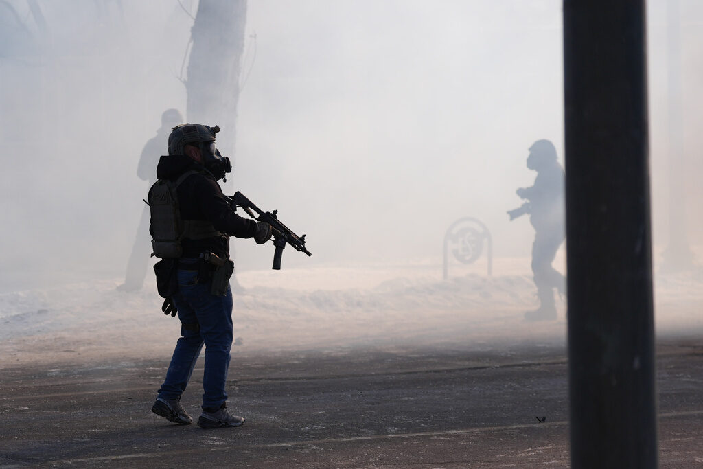 APTOPIX Immigration Enforcement Minnesota Federal immigration officers deploy tear gas after a shooting in Minneapolis