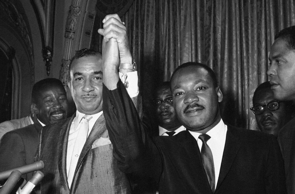 Cecil Moore, Martin Luther King Cecil Moore, left, NAACP, leader in Philadelphia, and Dr. Martin Luther King, integration leader, raises their hands in a gesture of unity in Philadelphia August 2, 1965, where Dr. King started a two-day visit. Moore earlier had requested Dr. King not to come here but they said the controversy was “a misunderstanding.” Dr. King hailed picketing at the all-white Girard College by the NAACP served to “dramatize the problem.” African American are attempting to break provisions of the college’s founder calling for only white students admitted. (AP Photo/Bill Ingraham )