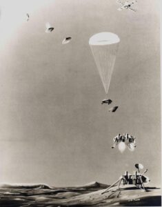 An artist's rendering of the different stages of the Viking landers' descents, including the lander, still attached to an orbiter at top right, the released lander at top left, its 3-5-hour descent through the thin atmosphere, discarding its aeroshell as its parachute deploys, retrorockets to further slow the lander, and finally, its landing. (NASA)