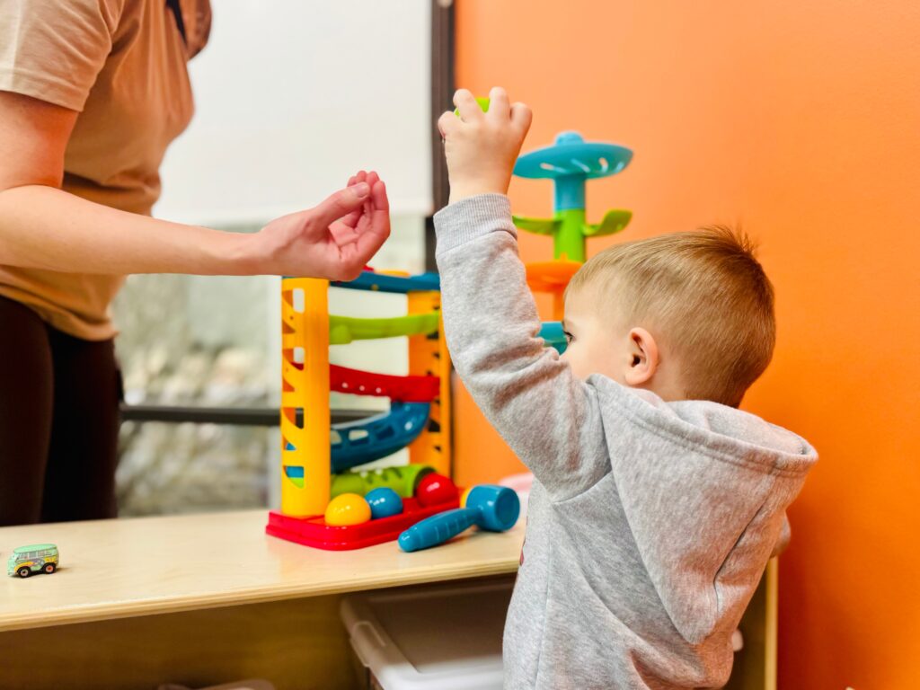 CHOP-Soar-autism-partnership-3 a child plays with a toy