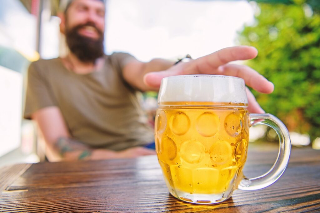 Drinking Alcohol Including Beer. Alcohol Free Beer. Chilled Beer Mug On Cafe Table. Refreshing Alcoh A chilled beer mug on cafe table. (photosvit/bigstock)