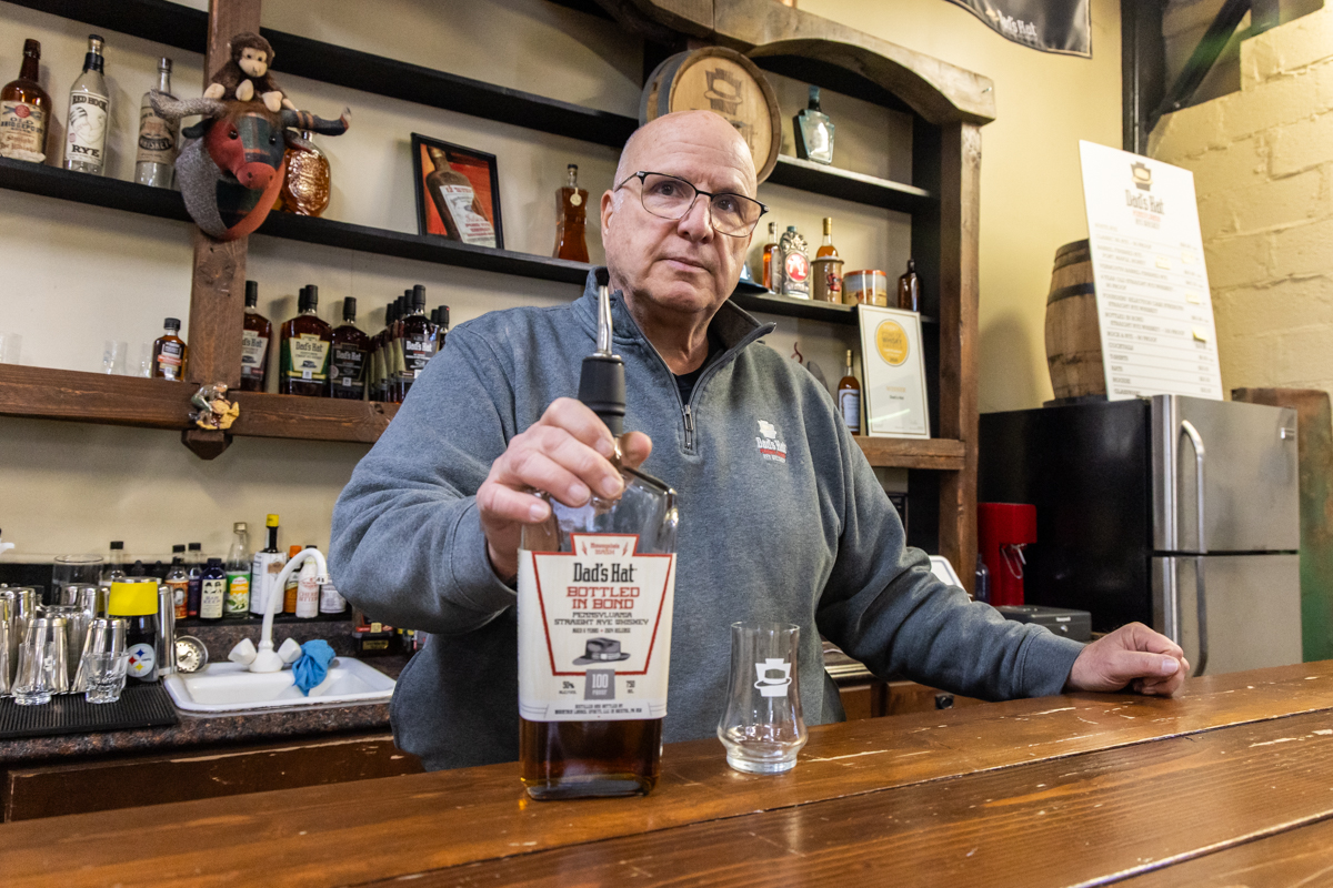 Dad's Hat Rye Whiskey founder Herman Mihalich behind the bar