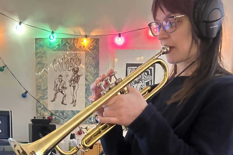 Emily Robb playing a trumpet in the recording studio