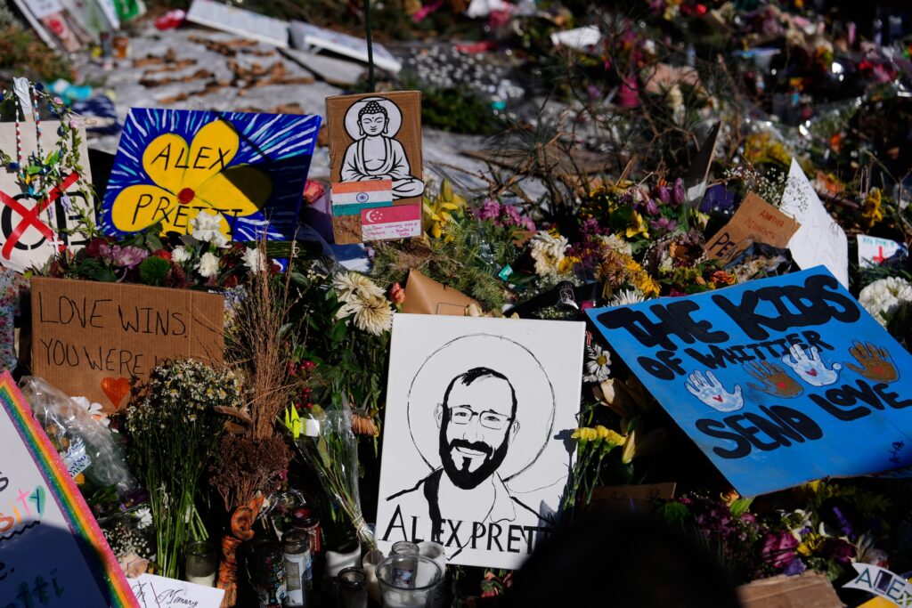Immigration Enforcement Minnesota A pen drawing of Alex Pretti is featured prominently in a makeshift memorial at the location where he was killed.