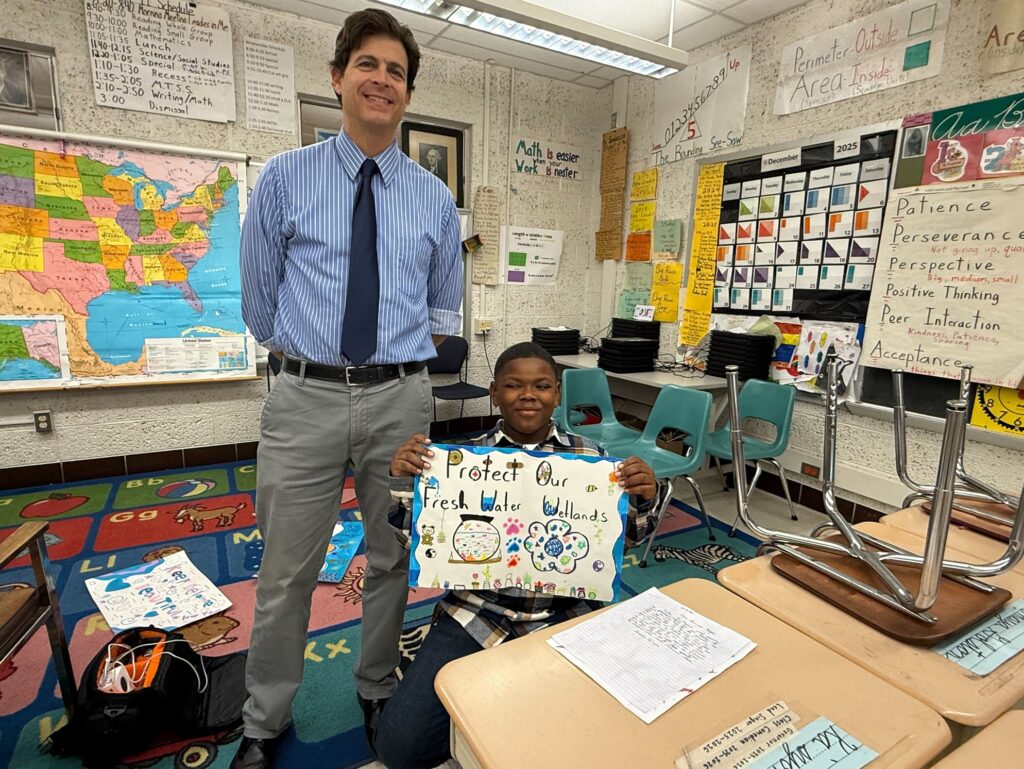 Fourth-grade teacher Paul Sedacca and a student