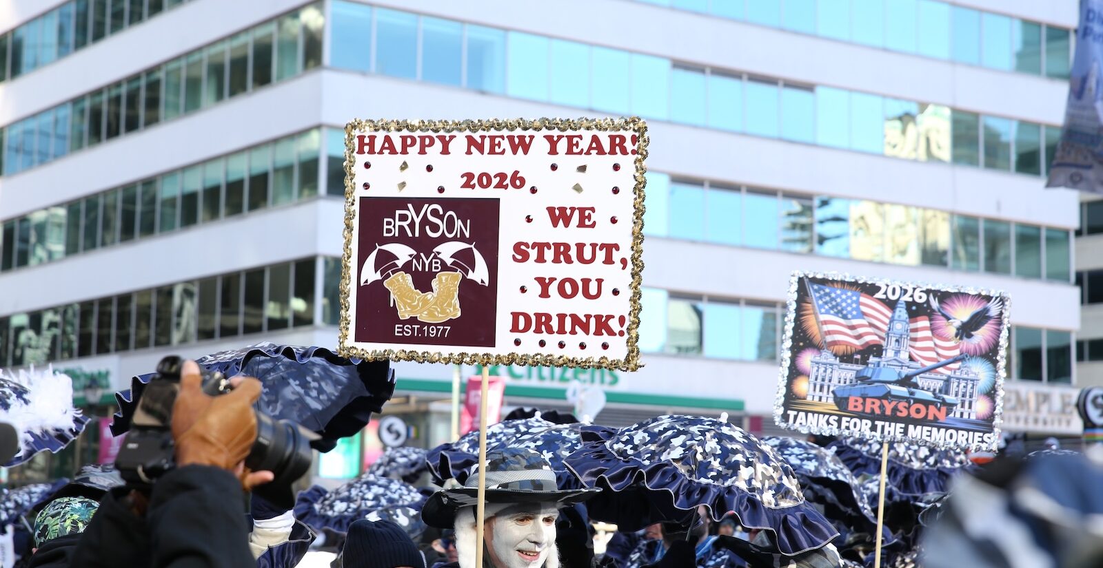 A sign at the 2026 Mummers Parade in Philadelphia reads, ''Happy new year, 2026, we strut, you drink''