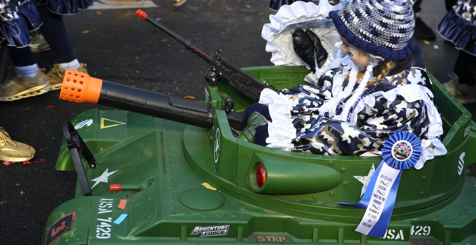 A child is seen in a parade float resembling a tank in the 2026 Mummers Parade in Philadelphia