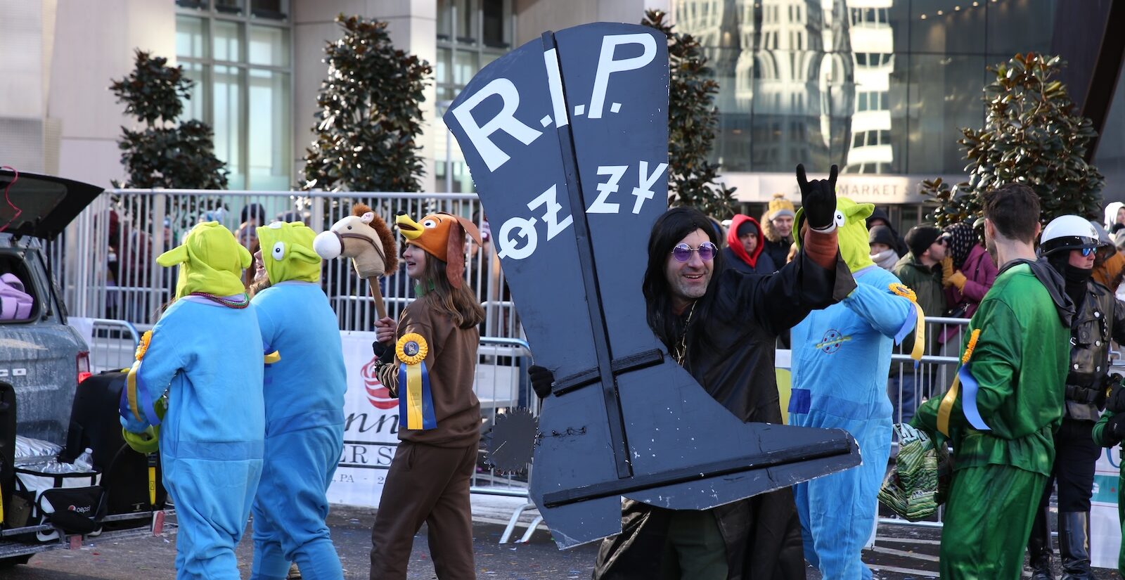A Mummer carrying a ''RIP'' sign pays tribute to Ozzy Ozbourne at the 2026 Mummers Parade in Philadelphia