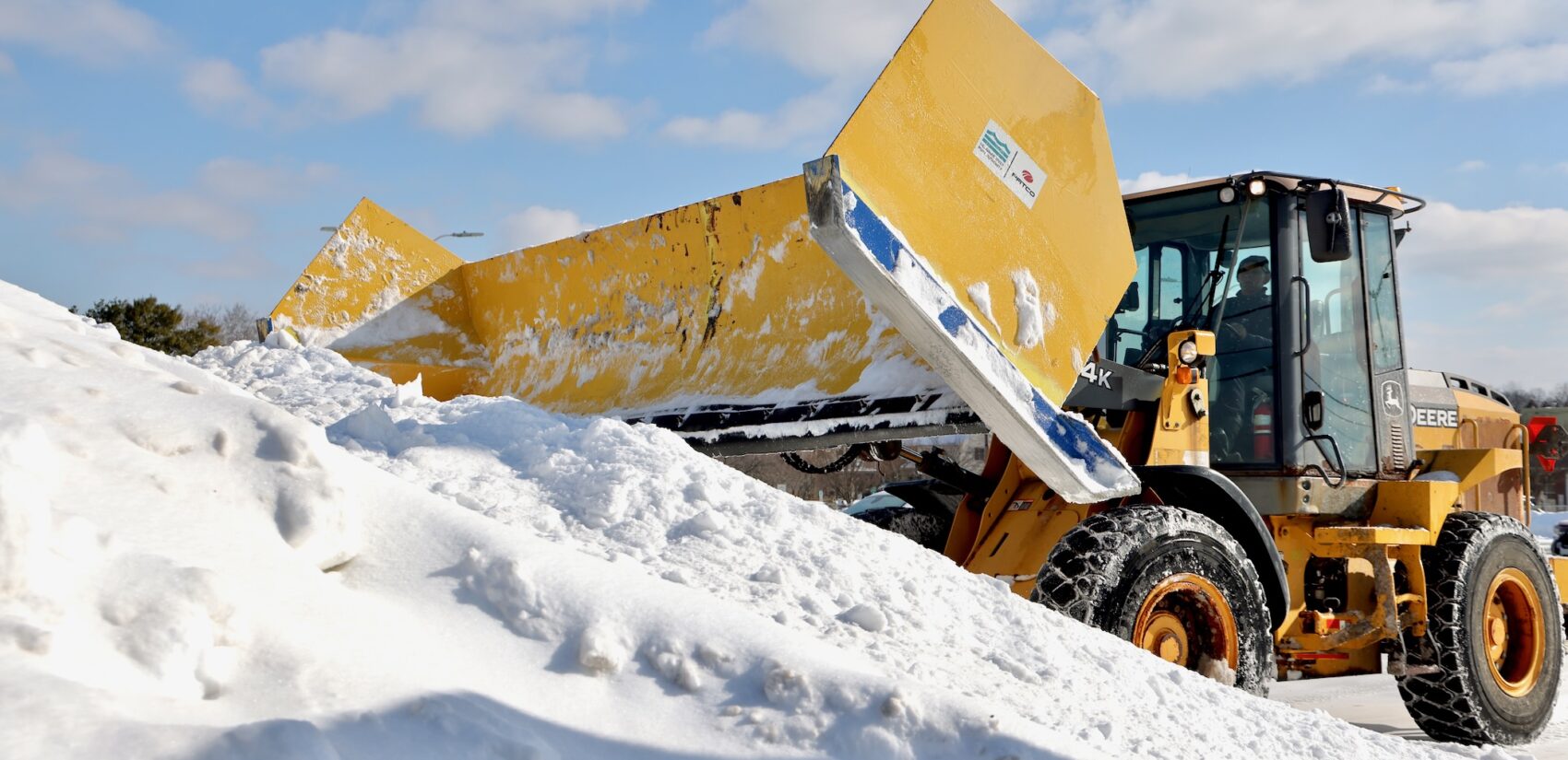 Snow piles up in great mounds as plows work to clear a parking lot in Haddonfield, N.J.
