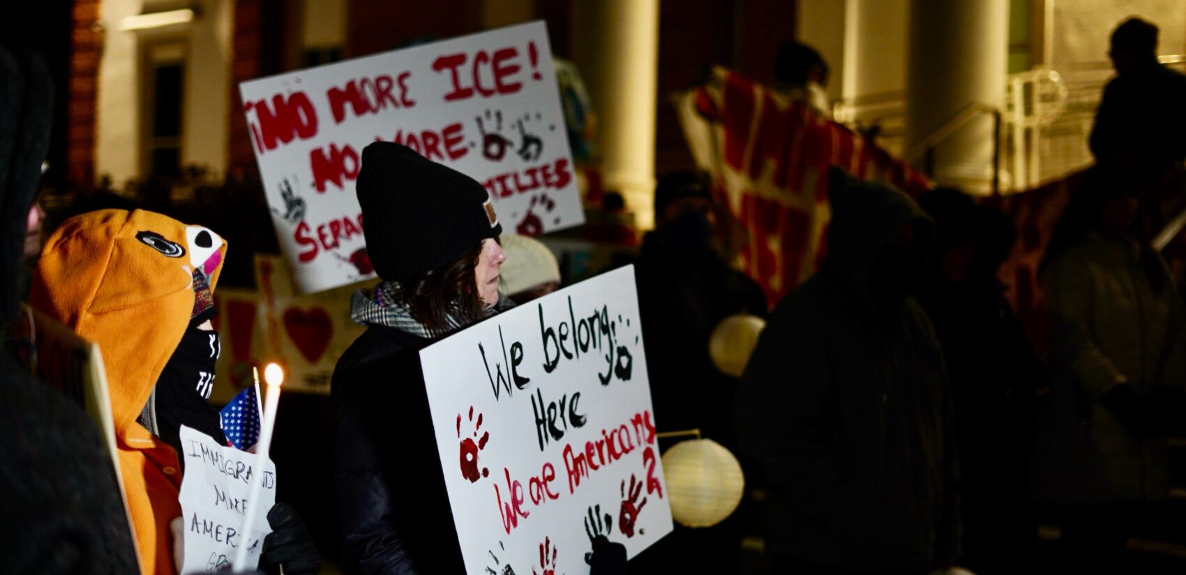 Advocates and community members hold a vigil outside of Norristown Municipal Hall condemning ICE's actions in Montgomery County. (Kenny Cooper/WHYY).