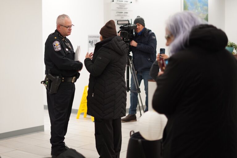 Denisse Agurto, the executive director of Unides Para Servir Norristown, speaks with Norristown Police Chief Michael Trail.