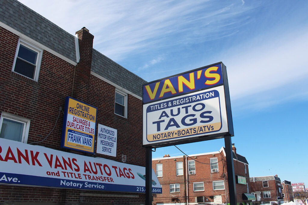A sign reads "Van's Auto Tags"