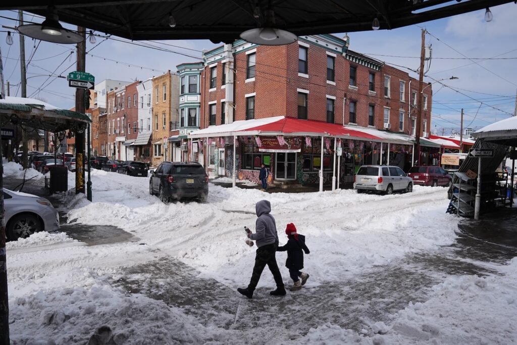 Winter Weather Philadelphia People cross a snow covered street in the aftermath of a winter storm in Philadelphia, Monday, Jan. 26, 2026.